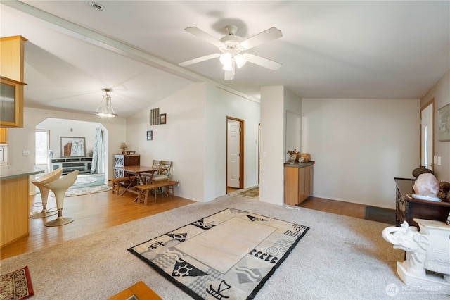 11712 114th Avenue Ct, Anderson Island, WA 98303 - living area featuring carpet flooring, ceiling fan, wood finished floors, and lofted ceiling