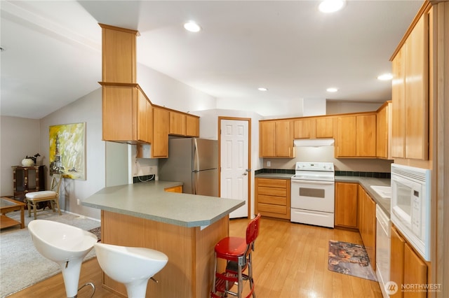 11712 114th Avenue Ct, Anderson Island, WA 98303 - kitchen featuring white appliances, a peninsula, a breakfast bar, lofted ceiling, and extractor fan