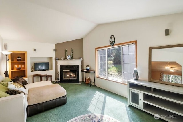 11712 114th Avenue Ct, Anderson Island, WA 98303 - living area featuring a high end fireplace, dark carpet, vaulted ceiling, and a healthy amount of sunlight