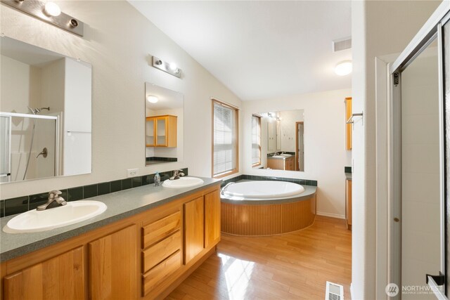 11712 114th Avenue Ct, Anderson Island, WA 98303 - bathroom featuring a sink, visible vents, a stall shower, and vaulted ceiling