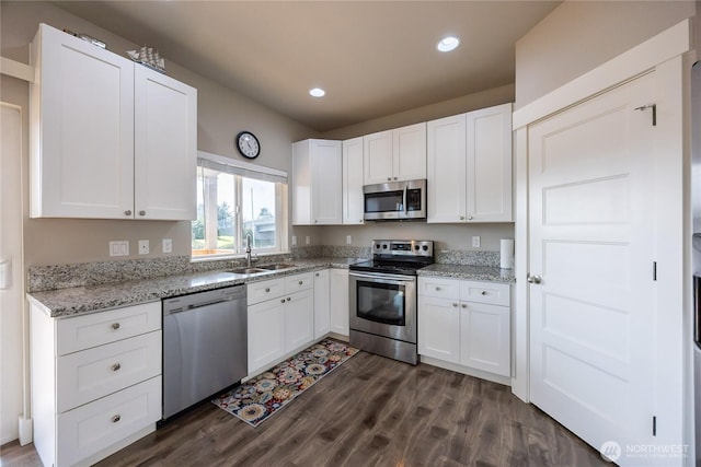 kitchen with white cabinetry, a sink, and appliances with stainless steel finishes
