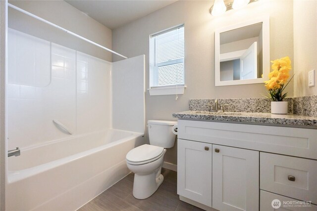 full bath with toilet, shower / bath combination, wood finished floors, and vanity