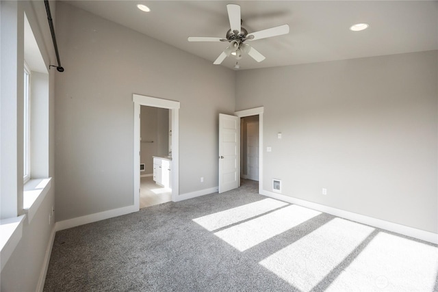unfurnished bedroom with baseboards, recessed lighting, vaulted ceiling, and light carpet