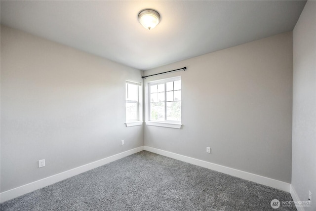 carpeted empty room with baseboards