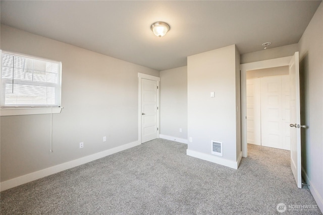unfurnished bedroom featuring visible vents, baseboards, and carpet floors