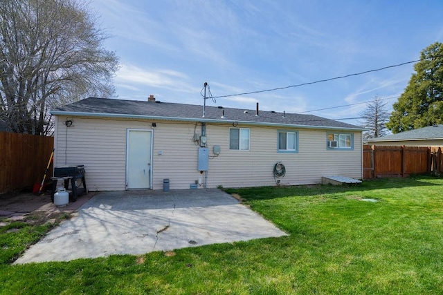 back of house featuring a yard, a fenced backyard, and a patio