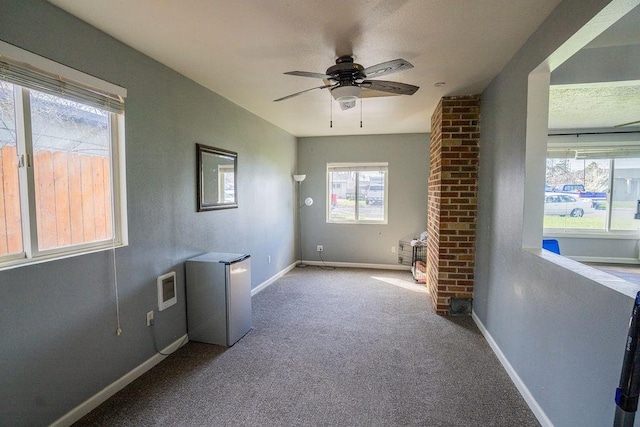 carpeted empty room with baseboards and ceiling fan