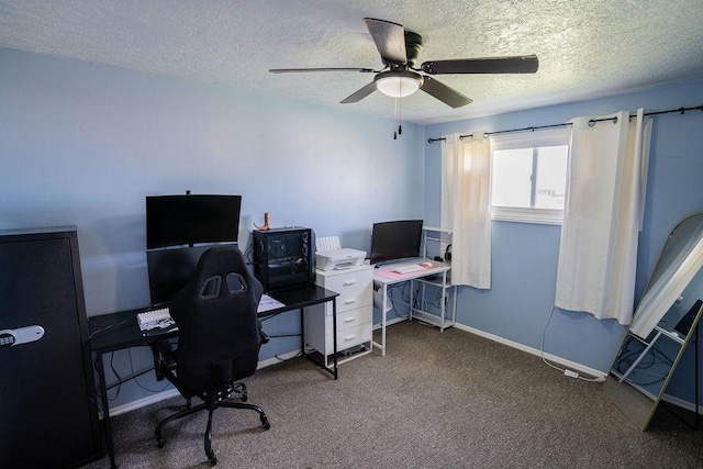 carpeted home office with a textured ceiling, baseboards, and a ceiling fan