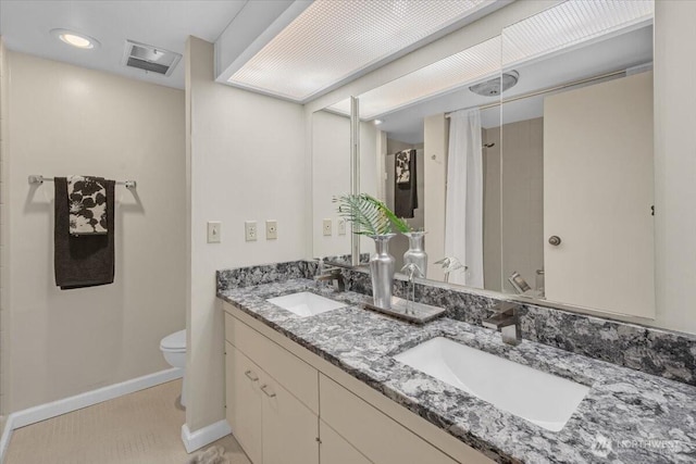 full bath featuring visible vents, toilet, baseboards, and a sink