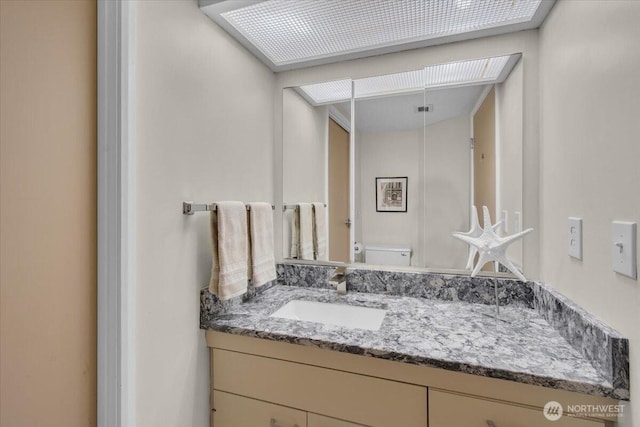 bathroom with toilet and vanity
