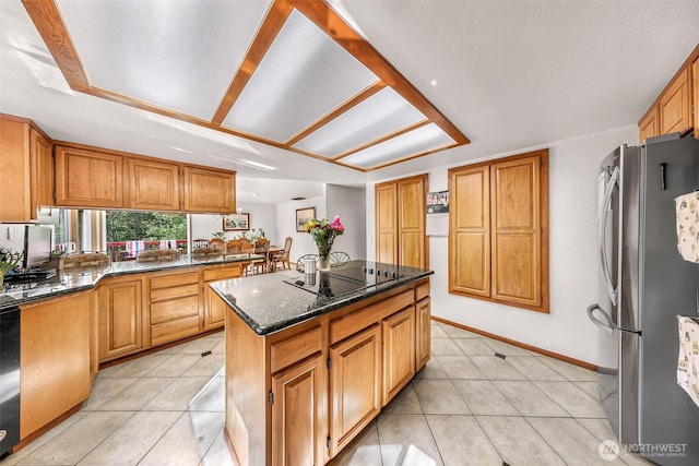 9652 Ronald Dr, Blaine, WA 98230 - kitchen featuring a center island, baseboards, freestanding refrigerator, dark stone countertops, and black electric stovetop