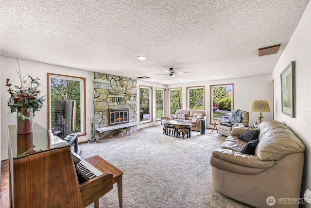 9652 Ronald Dr, Blaine, WA 98230 - carpeted living room featuring a fireplace, a ceiling fan, and a textured ceiling