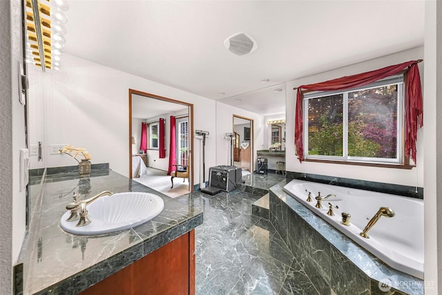 9652 Ronald Dr, Blaine, WA 98230 - full bathroom with a jetted tub, vanity, and marble finish floor