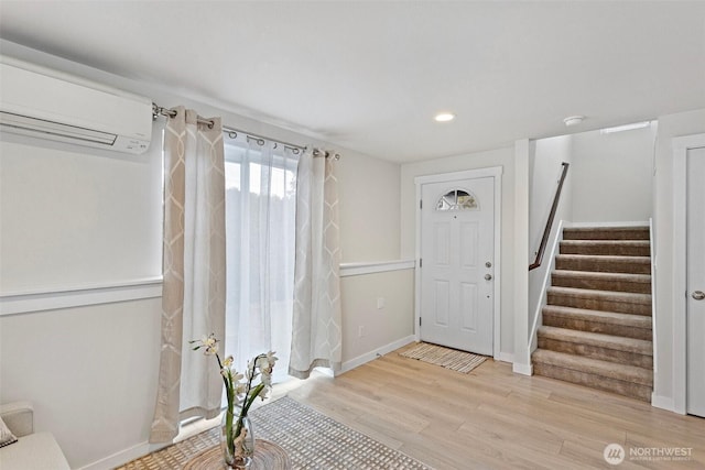 8015 Beacon Ave S Unit A, Seattle, WA 98118 - foyer entrance featuring light wood-style floors, a wall unit AC, recessed lighting, stairway, and baseboards