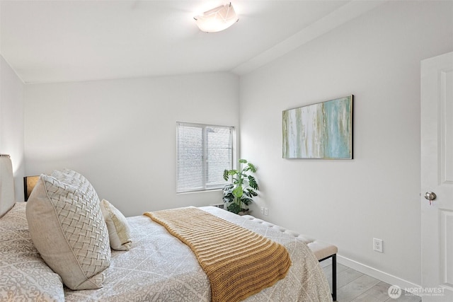 8015 Beacon Ave S Unit A, Seattle, WA 98118 - bedroom with baseboards, vaulted ceiling, and wood finished floors