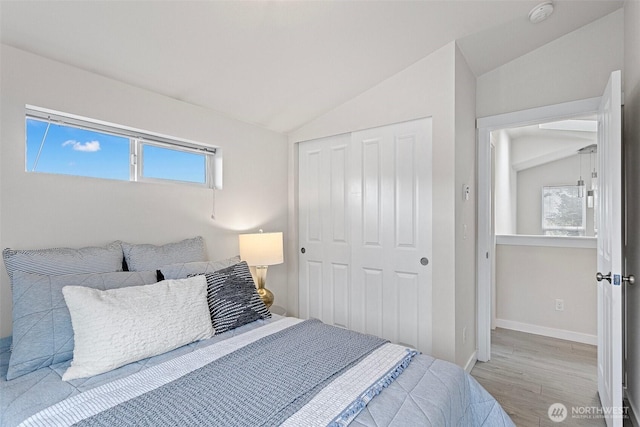 8015 Beacon Ave S Unit A, Seattle, WA 98118 - bedroom with a closet, baseboards, wood finished floors, and vaulted ceiling