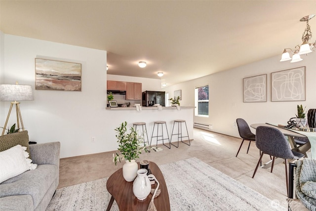 living area featuring light carpet, an inviting chandelier, and a baseboard radiator