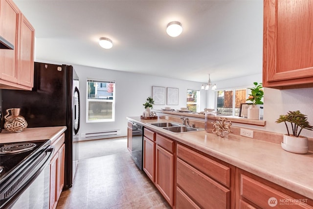 kitchen with a notable chandelier, a sink, light countertops, a baseboard radiator, and black appliances