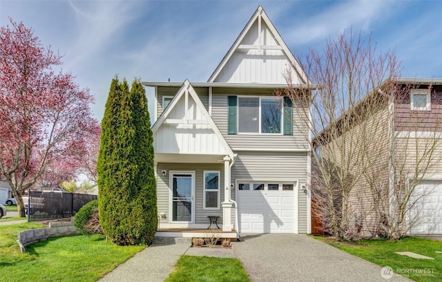 view of front of property featuring aphalt driveway, board and batten siding, fence, and an attached garage