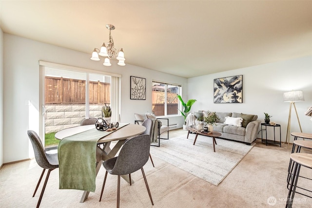 dining area featuring light colored carpet and an inviting chandelier