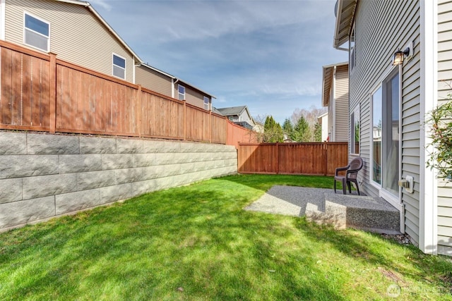 view of yard featuring a patio area and a fenced backyard