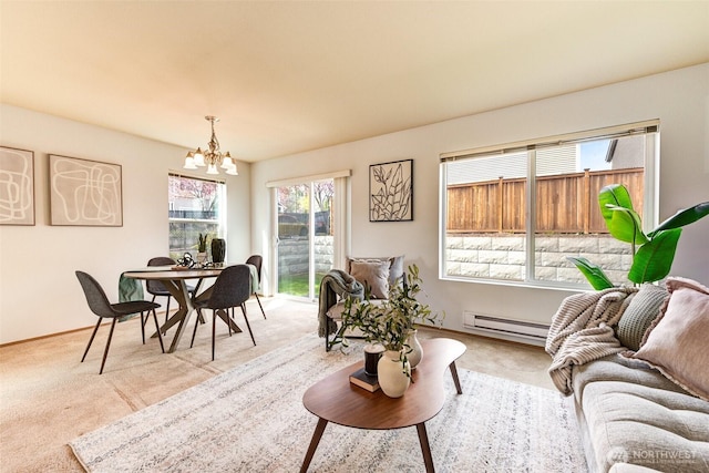 living room featuring a chandelier, light colored carpet, and plenty of natural light