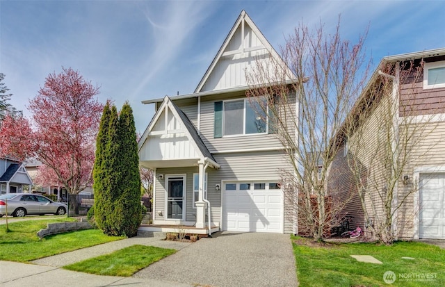 view of front of property with board and batten siding, a front yard, and an attached garage