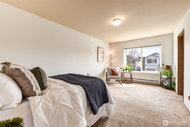 carpeted bedroom featuring baseboard heating
