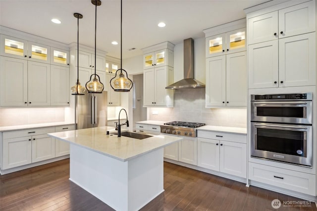 1332 247th Pl NE, Sammamish, WA 98074 - kitchen with wall chimney range hood, white cabinets, appliances with stainless steel finishes, dark wood-style flooring, and a sink
