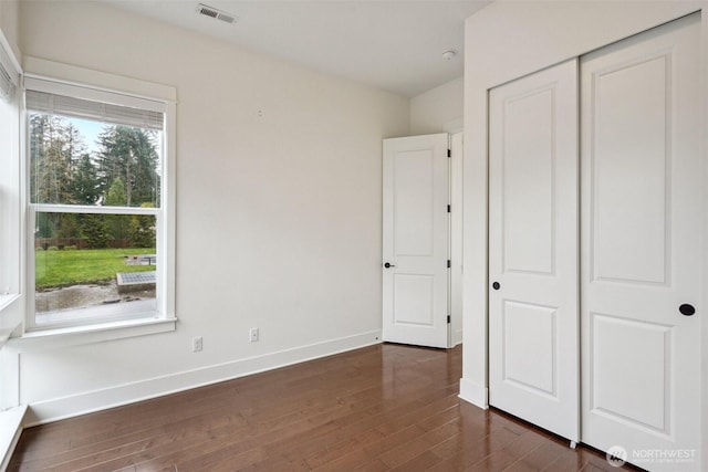 1332 247th Pl NE, Sammamish, WA 98074 - unfurnished bedroom with a closet, dark wood-type flooring, visible vents, and baseboards
