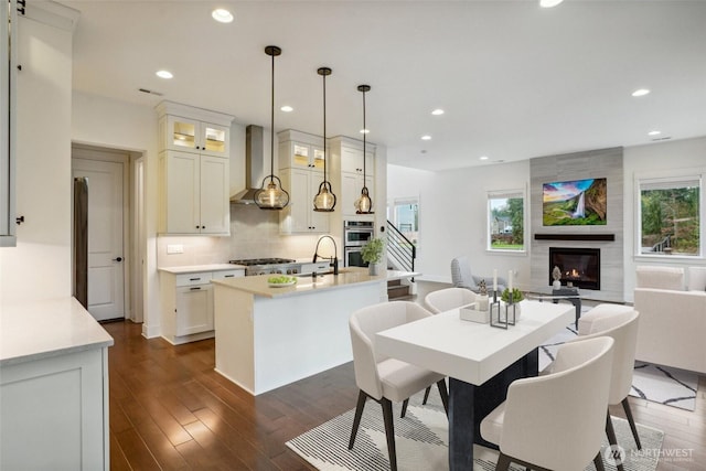 1332 247th Pl NE, Sammamish, WA 98074 - dining space with recessed lighting, dark wood-type flooring, and a large fireplace
