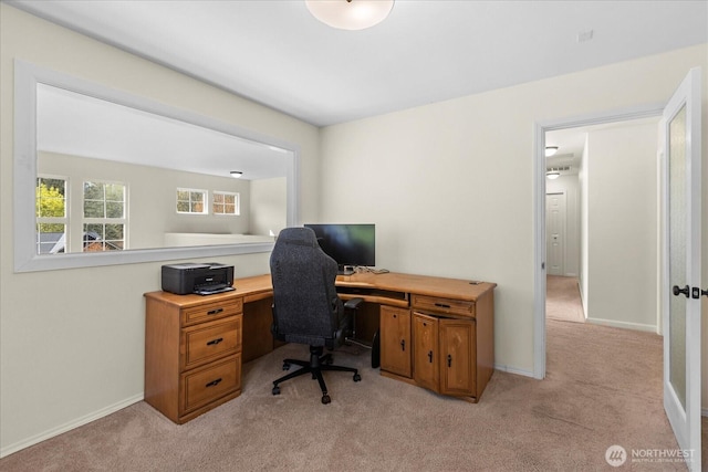 office with light colored carpet and baseboards