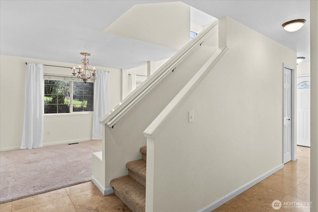 stairway with an inviting chandelier, carpet, visible vents, tile patterned floors, and baseboards