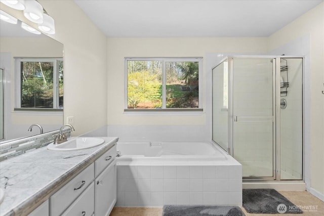 full bath with a shower stall, tile patterned floors, vanity, and a wealth of natural light