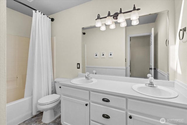 full bath featuring toilet, double vanity, shower / bath combo with shower curtain, and a sink