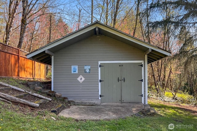 view of shed featuring fence