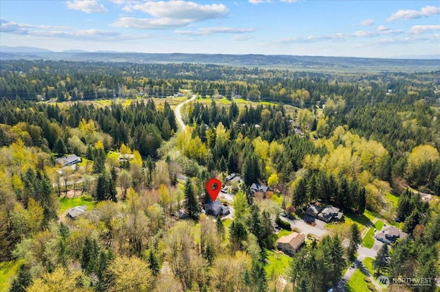 drone / aerial view featuring a forest view