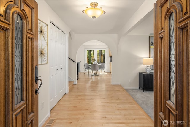 9115 SE 72nd Pl, Mercer Island, WA 98040 - foyer entrance with light wood-type flooring, baseboards, stairway, visible vents, and arched walkways