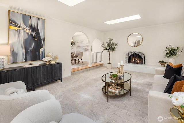 9115 SE 72nd Pl, Mercer Island, WA 98040 - living room featuring ornamental molding, a skylight, arched walkways, and a fireplace