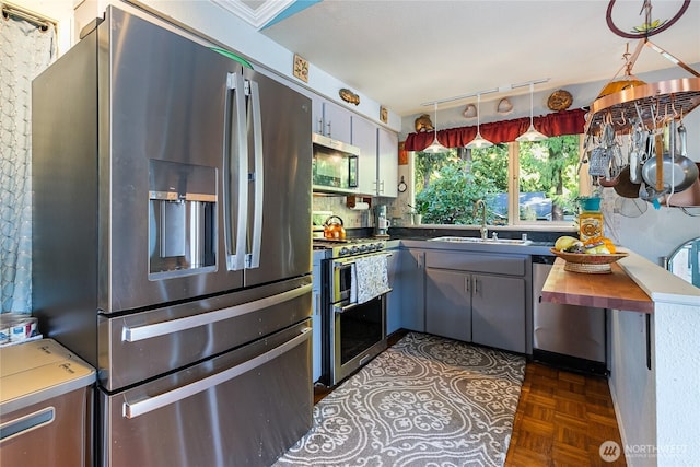 69 N Pt, Bellingham, WA 98229 - kitchen featuring track lighting, gray cabinets, dark countertops, appliances with stainless steel finishes, and a sink