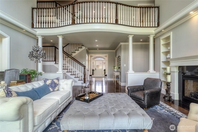 2001 Stillwater Dr, Walla Walla, WA 99362 - living room with wood finished floors, a high ceiling, ornamental molding, and stairs