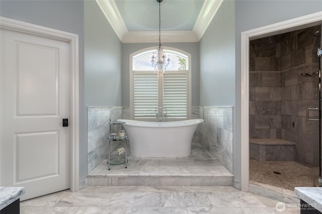 2001 Stillwater Dr, Walla Walla, WA 99362 - bathroom with crown molding, a soaking tub, a wainscoted wall, a stall shower, and a notable chandelier