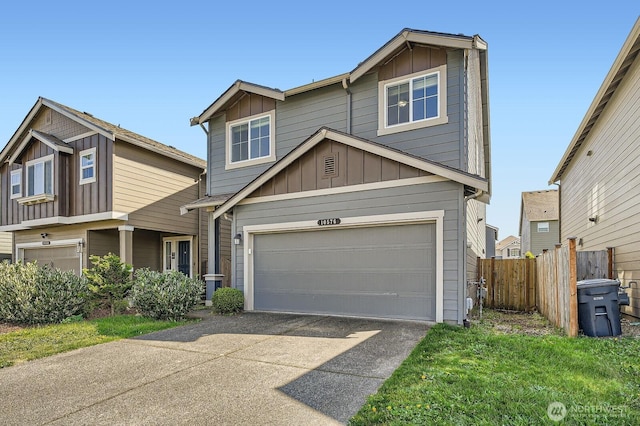 view of front of home featuring board and batten siding, fence, an attached garage, and driveway