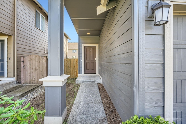 view of exterior entry with fence
