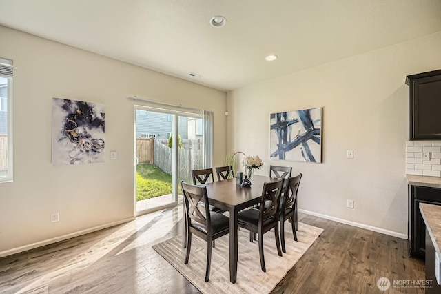 dining space with recessed lighting, baseboards, visible vents, and wood finished floors