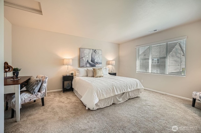 carpeted bedroom featuring baseboards and visible vents
