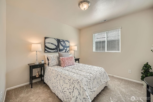 carpeted bedroom with baseboards and visible vents