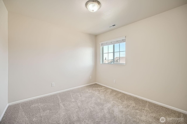 carpeted spare room with baseboards and visible vents