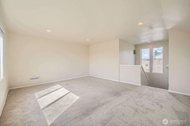 spare room featuring visible vents, recessed lighting, baseboards, and carpet floors