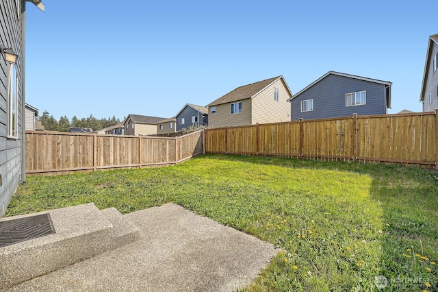 view of yard featuring a residential view and a fenced backyard